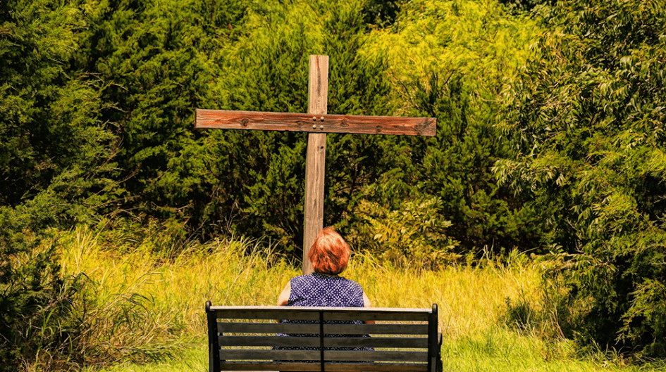 And to which of the "holy ones" will you turn? A woman looking at a cross