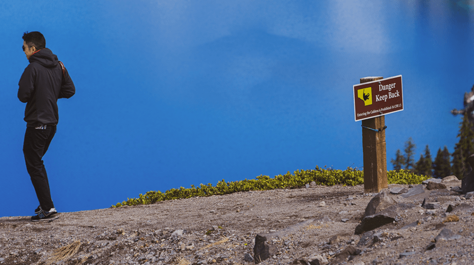 Man walking towards cliff